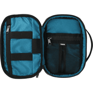A toiletry bag featuring a teal interior, black zippers, and storage compartments. It has a brand logo inside.