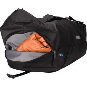 A black duffel bag with a mid blue accent, featuring a large opening and an orange interior. The bag has a logo.