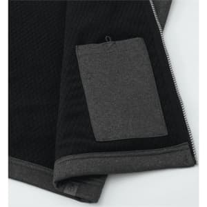 A black and dark grey softshell vest featuring a textured design and a small pocket on the side.