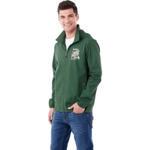 A man is wearing a green packable jacket with a hood and a logo on the front. The jacket is styled for rain protection.
