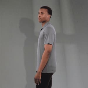 A men's eco-friendly polo shirt in grey, featuring a subtle logo, displayed in a side view against a neutral background.