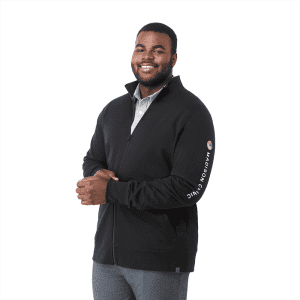 A man is wearing a black full zip fleece jacket with a logo on the sleeve. The jacket features a high collar.