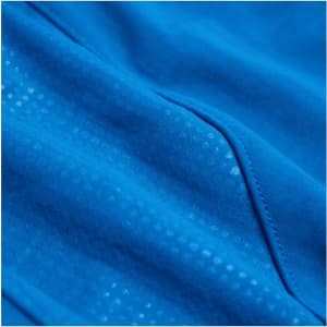 A close-up of a bright blue fabric with a textured pattern, featuring seams and details from a full zip jacket.