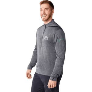 A smiling man wearing a grey eco-knit performance half zip jacket with a logo on the sleeve.