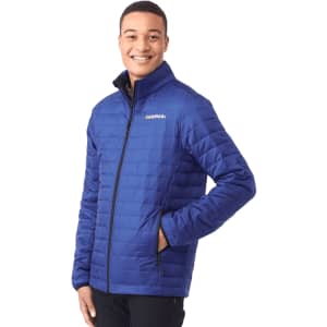 A man wearing a blue lightweight packable insulated puffer jacket with a logo on the chest.