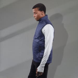 A men's lightweight packable insulated puffer vest in navy, featuring a zippered pocket and a logo.