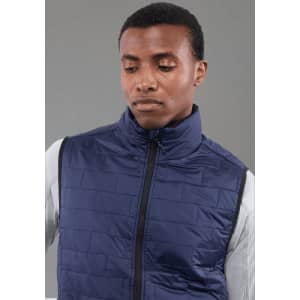 A navy lightweight packable insulated puffer vest on a model, featuring a high collar and zip closure.