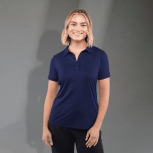 A navy blue women's polo shirt featuring a collar and a logo. The model stands against a neutral backdrop.