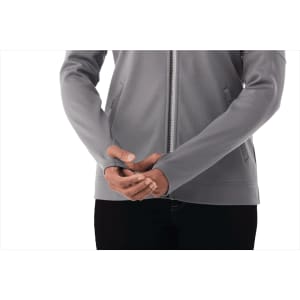 A lightweight grey full zip performance jacket featuring thumb holes, with a fitted silhouette and a branding logo.