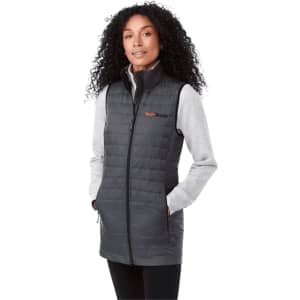 A lightweight packable insulated puffer vest in grey, featuring a high collar and pockets, worn with a grey long-sleeve top.