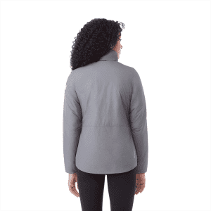 A woman wearing a grey insulated puffer jacket, shown from the back, featuring a logo on the sleeve.