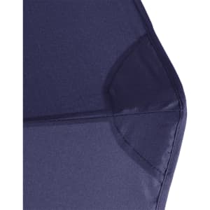 A close-up of the corner of a navy blue vented tipless golf umbrella featuring a structured design.