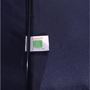A navy blue vented tipless golf umbrella with a tag featuring a logo and recycling symbol.