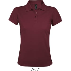 A women's polo shirt in burgundy, made of 65% polyester and 35% ring spun cotton, featuring a logo.