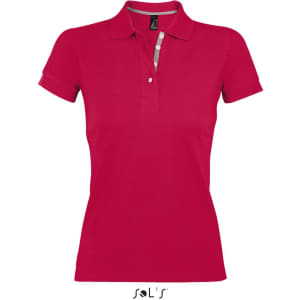 A women's polo shirt in vibrant red, made from 100% ring spun cotton, featuring a branded label.