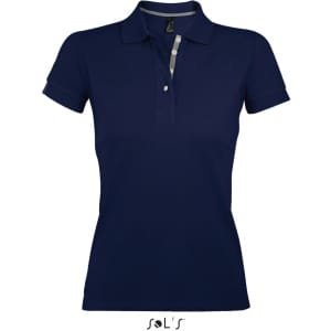 A navy women's polo shirt made from 100% ring spun cotton, featuring a collar and button placket. It has a logo.