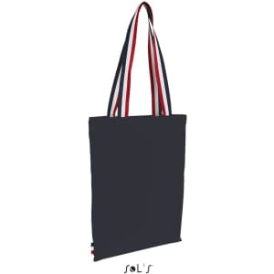 A navy shopping bag with striped handles in red and white, featuring a logo.