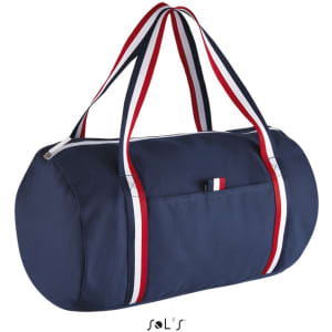 A navy duffel bag with red, white, and blue striped handles and a zip closure. It features a side pocket and branding.