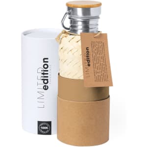 A drink bottle in a cylindrical packaging, featuring bamboo-style elements and a metal lid, in white and brown tones.