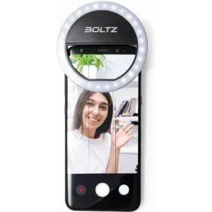 A smartphone with a circular ring light attached, featuring a woman smiling in a selfie. The device has a logo on it.