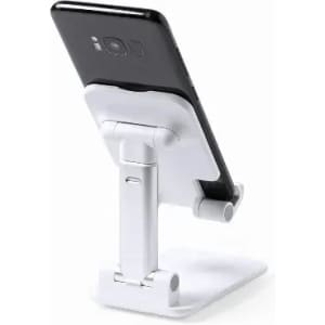 A phone stand in white, holding a black smartphone upright. The stand features an adjustable design.