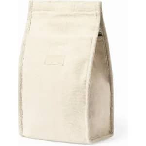 A natural beige fabric bag with a structured design and a flap closure. It has a minimalistic look and no visible logo.