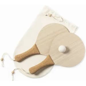 Two wooden paddle beach bats with cork handles and a lightweight white ball, accompanied by a beige storage pouch.
