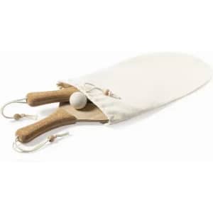 A wooden paddle and ball set with cork handles, enclosed in a beige fabric pouch.