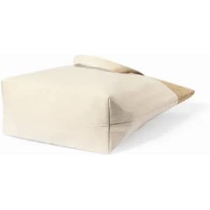 A tote bag in cream with a textured natural base and a sturdy handle. Features a simple design.