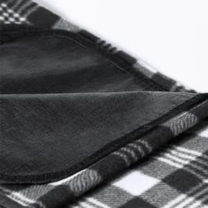 A blanket featuring a black and white checkered pattern, with a soft texture and neatly stitched edges.