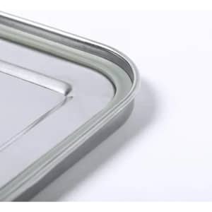 A metal tray with a curved edge, featuring a smooth, shiny surface and a minimalistic design.