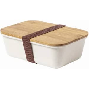 A container with a bamboo lid and a brown strap, featuring a white base. It has a simple, modern design.