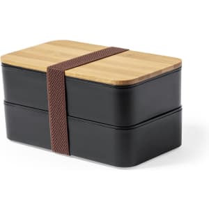 A lunch box featuring a black exterior and a bamboo lid, secured with a brown strap. It has two stacked compartments.