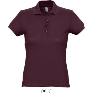 A maroon women's polo shirt made from 100% ring spun cotton, featuring a collar and buttons. It has a logo.