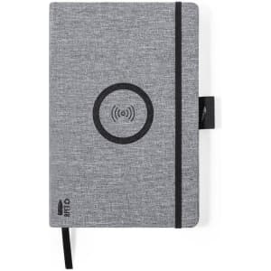 A grey notebook with a textured cover, featuring a circular logo and an elastic band closure.