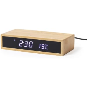 A wooden alarm clock with a digital display showing the time and temperature. It has an elegant, minimalist design.