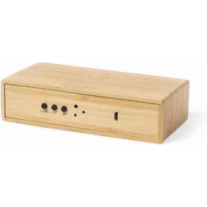 A wooden speaker with a sleek design, featuring control buttons and a USB port on the front.
