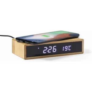 A wooden clock with a charging pad on top, displaying the time and temperature in digital format.