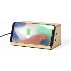 A wooden charging dock with a smartphone placed on it, displaying a low battery icon. The dock has multiple ports.
