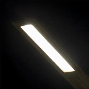 A sleek, rectangular LED light emits a bright white glow against a dark background.