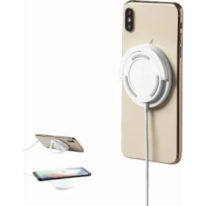 A wireless phone charger in white, positioned on the back of a gold smartphone, with a cable connected.