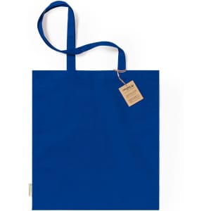 A blue tote bag with two handles and a decorative tag attached.