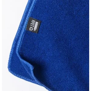 A blue microfibre cloth with a textured surface and a small tag indicating it is made from recycled materials.
