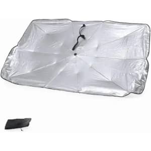 A beach mat in silver with a black trim, folded neatly in a compact size. It features a fastening strap.