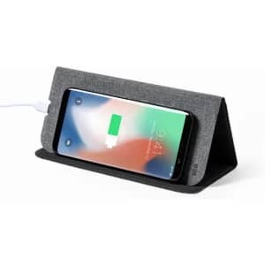 A phone charging stand featuring a grey fabric cover and a black base, perfectly positioned for wireless charging.