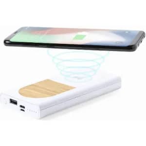 A wireless phone charger with a wooden surface, featuring USB ports, in a white casing.