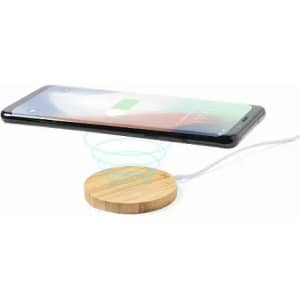 A wireless charging pad with a bamboo surface and a smartphone hovering above it, indicating charging in progress.