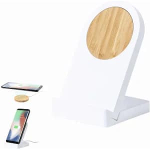 A white wireless charging stand with a wooden circular top, featuring a phone charging beside it.