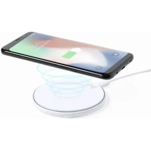 A wireless charging pad in white with a smartphone placed on top, indicating it is charging.