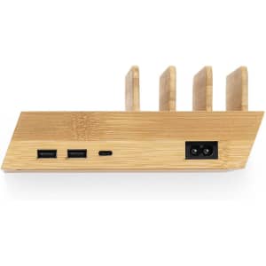 A bamboo charging station with multiple slots and various ports, including USB and USB-C options.